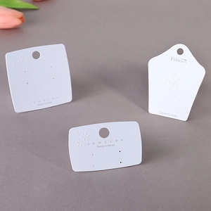 Elegant white jewelry display cards in various shapes for earrings and brooches