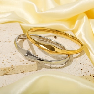 Minimalist geometric stainless steel bracelets in gold and silver finish on silk fabric