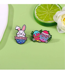 Close-up of enamel Easter bunny pins with Happy Easter banner and colorful painted eggs