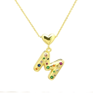 Detail of 3D gold balloon letter M pendant with multicolored crystal inlay on heart clasp