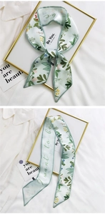 Detail of mint green floral silk scarf with Be You text and elegant flower pattern