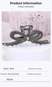 Detail of rhinestone bow hair claw clip with grey pearl accent on a pedestal