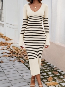 Full-length view of an elegant beige striped knit dress with V-neck and long sleeves