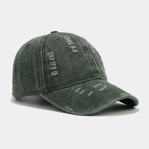 Close-up of distressed baseball cap details with vintage washed texture and ripped holes