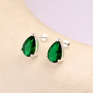 Macro view showing S925 hallmark on silver backing of emerald teardrop stud earrings