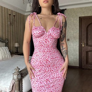 Close-up detail of pink floral summer dress featuring tie-up ribbon straps and ruched bust design