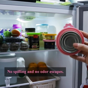 Silicone pet food can cover sealing a pink tin being placed into a refrigerator