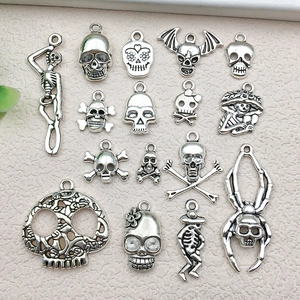 Detailed view of assorted antique silver skull alloy pendants for DIY jewelry crafting