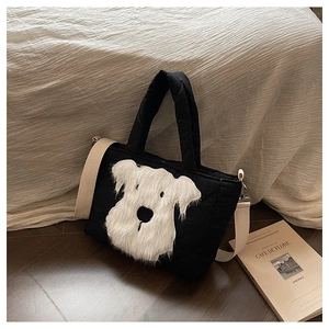 Detail view of quilted black tote bag featuring a plush white schnauzer dog design