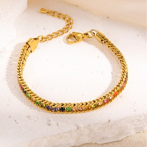 Macro shot of gold tennis bracelet with multi-color zircons and lobster clasp closure
