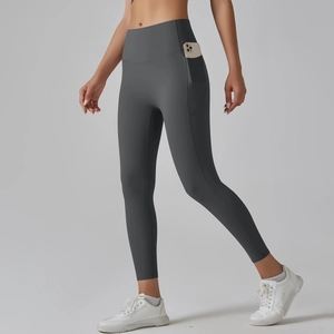 Detail view of high waist yoga leggings showing the functional side phone pocket in dark grey