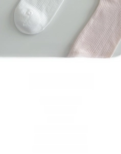 Detailed view of white and pink ribbed cotton crew socks with sweet lace cuffs