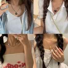 Collage of four minimalist necklaces with flower, heart, pearl and bear pendants on a model