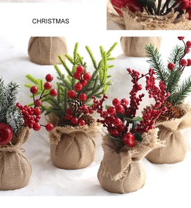 Detail of mini Christmas tree featuring pine cones, red berries and burlap base