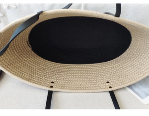 Detail view of woven cotton rope beach tote bag base with black center and metal rivets