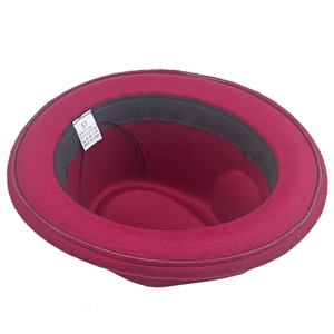 Detail view of wine red jazz hat interior with cotton polyester fabric care label