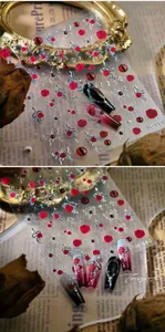 Close-up of M-980 gothic nail stickers with red rose and silver butterfly patterns
