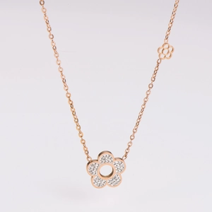 Macro detail of rose gold flower pendant with sparkling zircon and hollow design