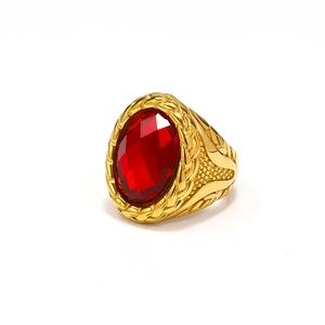 Detailed close-up of the vintage gold ring featuring a large oval red gemstone and woven texture