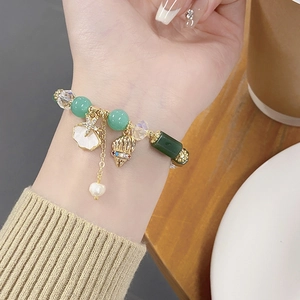 Detailed shot of ocean-themed beaded bracelet with starfish and shell pendants