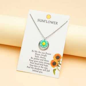 Silver sunflower pendant necklace displayed on an inspirational poetry display card