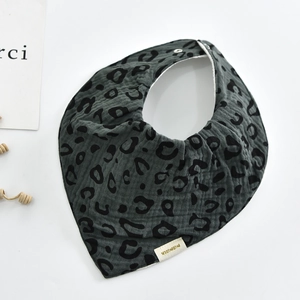 Detail of soft cotton baby bib with dark grey leopard print and snap button closure