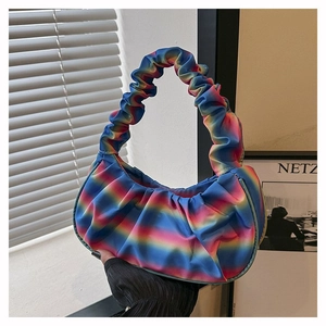 Detail of colorful rainbow pleated dumpling bag with soft clouds design and smooth satin texture