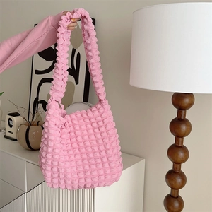 Detailed close-up of pink bubble textured crossbody bag showing elastic 3D grid fabric design