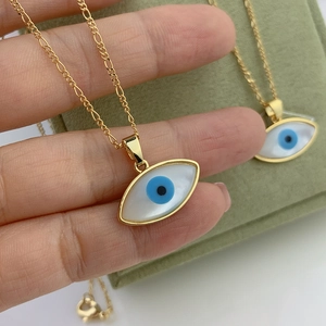 Golden Figaro chain necklace with oval mother of pearl evil eye pendant in a gift box