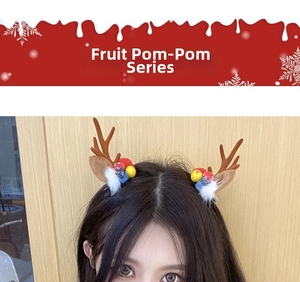 Close-up of model wearing cute brown reindeer antler hair clips with colorful berry pom-poms