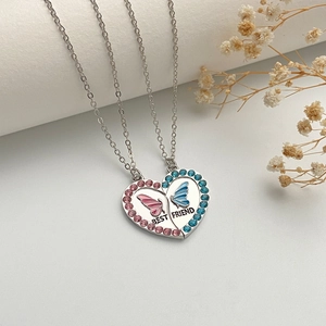 Silver butterfly BFF friendship necklaces with pink and blue rhinestones on white background