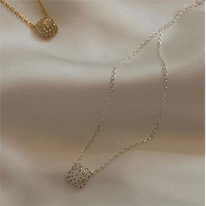 Elegant gold and silver square cubic zirconia pendant necklaces on white silk