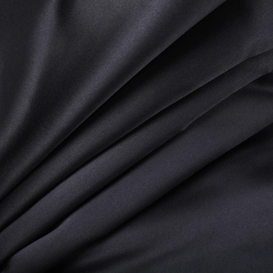 Detailed macro shot of premium black mesh fabric with smooth texture and soft folds
