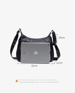 Black pebbled leather saddle bag size comparison with tablet showing 32x24x11 cm dimensions