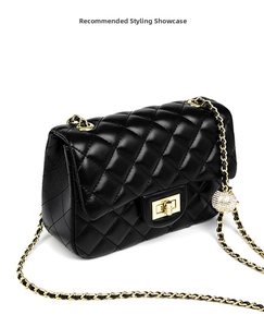Detail of adjustable gold ball buckle on black quilted leather strap chain for shoulder bag