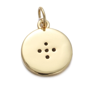 Macro detail of round golden button-style pendant with four holes and polished finish