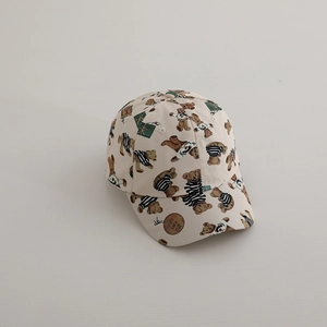 Close-up of beige kids baseball hat with bear patterns and brown round leather patch