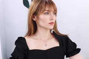 Silver heart pendant necklace shown on a model for an elegant vintage style jewelry look