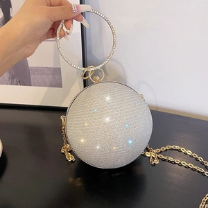 Spherical evening clutch bag with sparkling crystals and golden metal chain strap