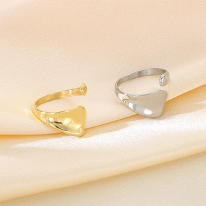Detail of minimalist 18K gold and silver plated irregular wavy open rings on silk
