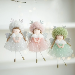Detailed view of three plush Christmas angel dolls in white, pink, and green colors