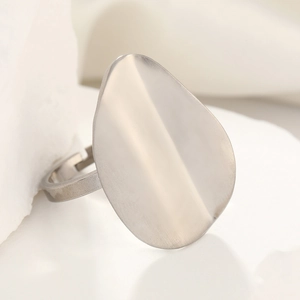 Macro detail of silver titanium steel ring with irregular flat surface and adjustable band