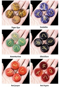 Detail showing hand-carved gold sigils on various natural crystal stone discs with textures