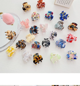 Close-up of assorted acetate mini hair claws in marble and tortoiseshell patterns