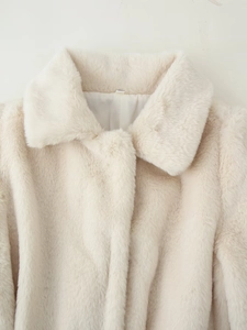 Detail of soft cream faux fur jacket showing the plush collar and long hair texture