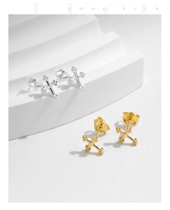 Detailed view of s925 silver cross stud earrings in gold and silver finishes