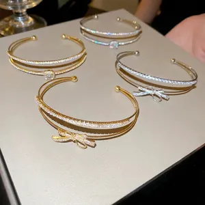 Elegant gold and silver double-layer bow bracelets set with sparkling cubic zirconia