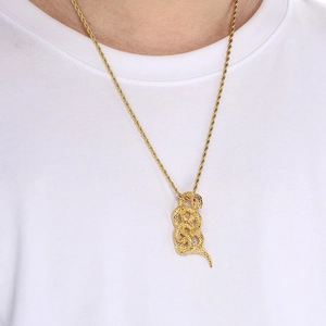 Detail of 18k gold coiled snake pendant on twisted rope chain worn by a female model