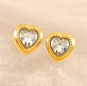 Macro view of gold stainless steel heart stud earrings with zircon stone and beaded border