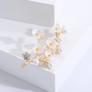 Elegant gold flower branch brooch with white shells, pearls and sparkling crystals
